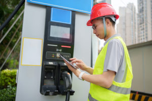 Workers inspect car charging facilities
