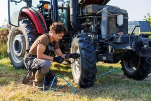 Man working on tractor tyres